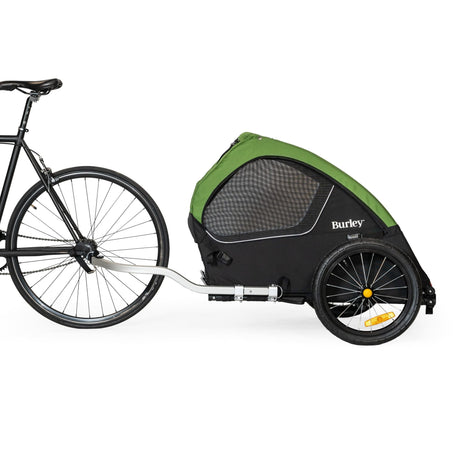 Burley Tail Wagon hitched behind a black bike, side view showing the aluminium tow bar and 16 inch wheel