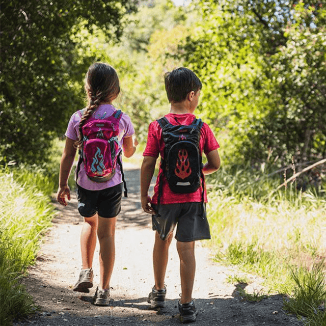 Two children walking a bush track wearing CamelBak Mini M.U.L.E. packs