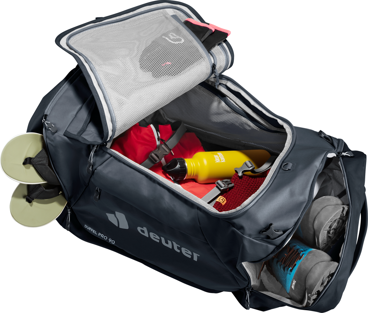 Deuter Duffel Pro 90 arch zip opened wide, packed with travel gear and inner mesh pocket
