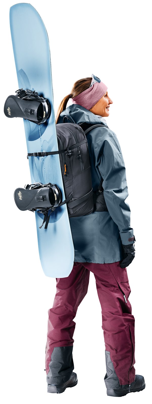 Woman wearing the Deuter Freerider 28 SL with a snowboard strapped to the front