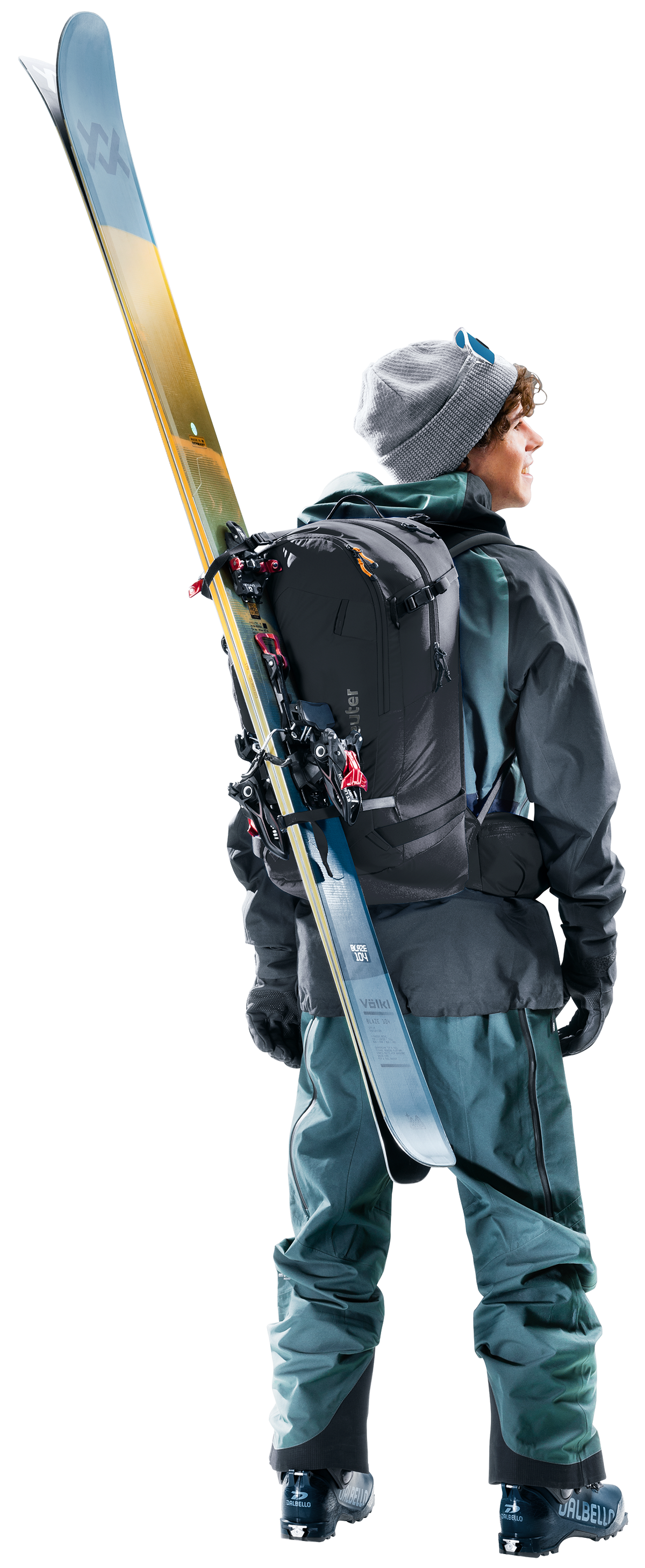 Skier wearing the Deuter Freerider 30 with skis carried diagonally across the back