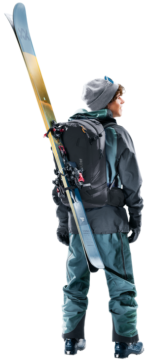 Skier wearing the Deuter Freerider 30 with skis carried diagonally across the back