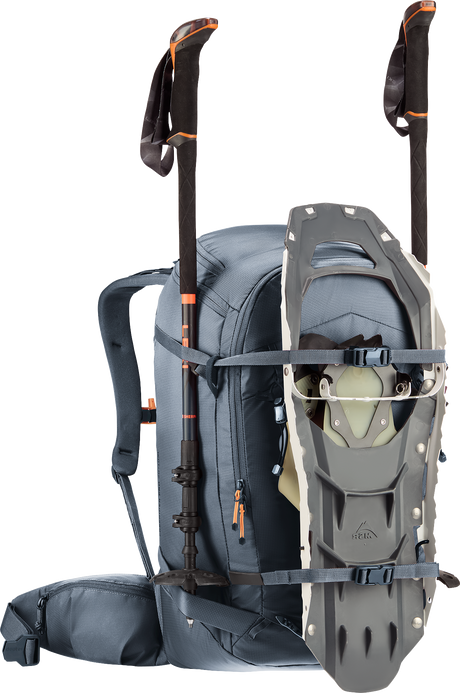 Deuter Freerider Pro 30+10 SL carrying snowshoes on the front and poles at the sides