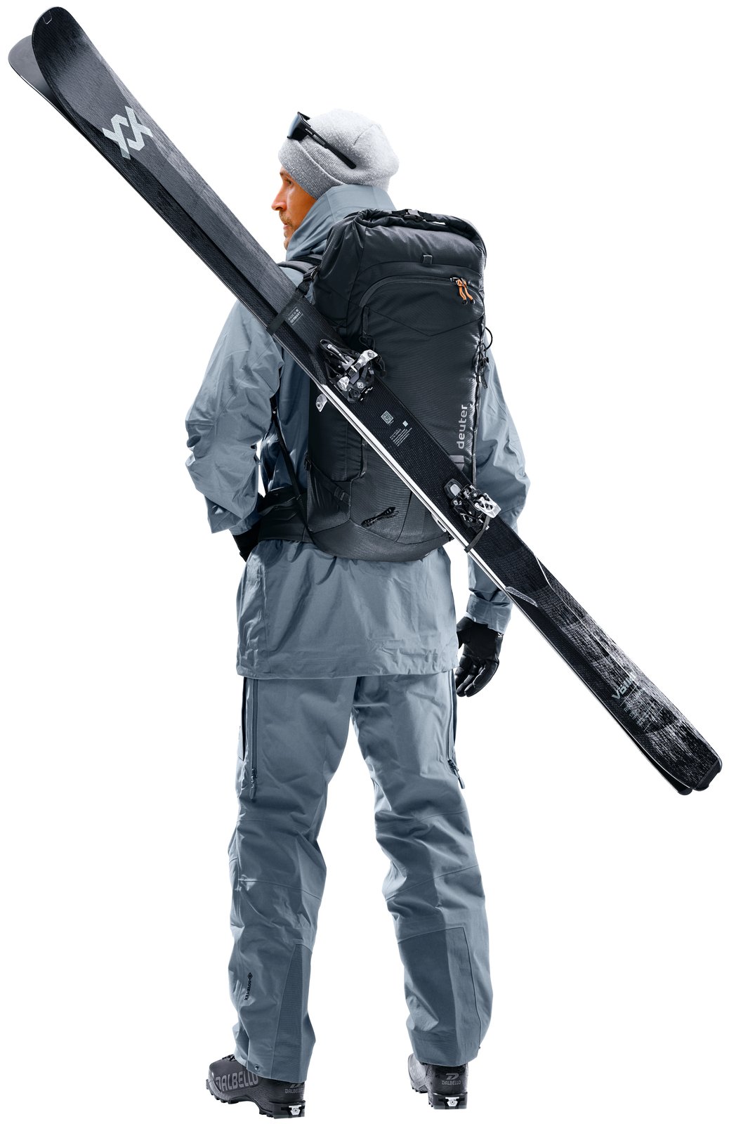 Ski tourer wearing the Deuter Freescape Lite 26 with skis carried diagonally
