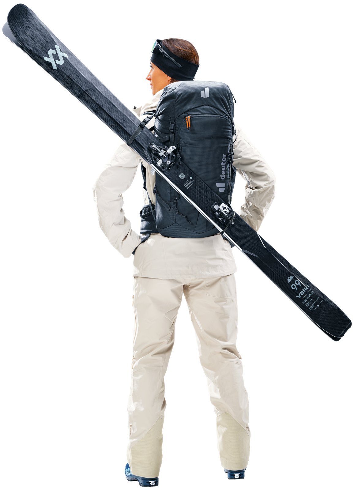 Skier wearing the Deuter Freescape Tour 30 SL with skis carried diagonally across the back