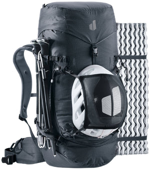 Deuter Guide 34+6 with folded trekking poles at the side, a helmet in the mesh holder and a foam mat strapped on