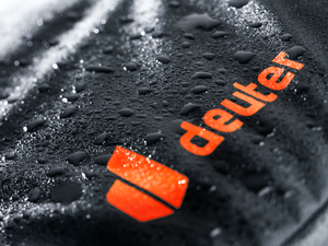 Close-up of water beading on the TPU-coated fabric of the Deuter Jaypack Pro 34+14 by the logo