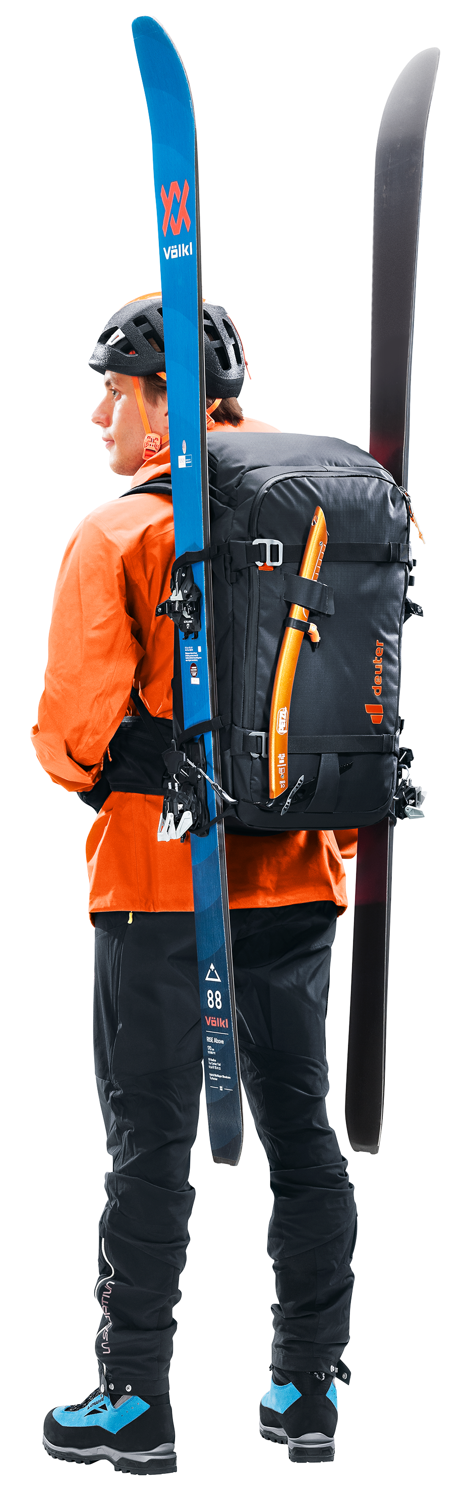 Skier in an orange jacket carrying skis on the side of the Deuter Jaypack Pro 34+14
