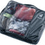 Deuter Mesh Zip Pack 10 in Black, packed with clothes visible through the mesh top