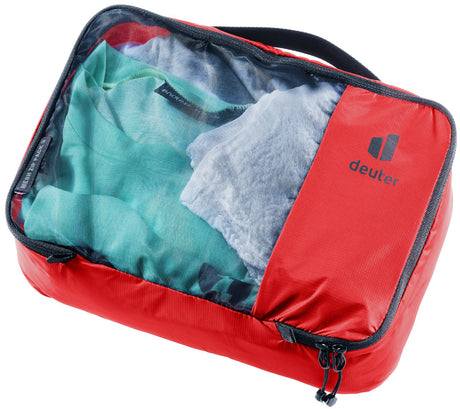 Deuter Mesh Zip Pack 3 packing cube in Cherry red, closed, with clothes visible through the mesh top