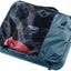 Deuter Mesh Zip Pack 5 in Atlantic blue, packed with folded clothes visible through the mesh top