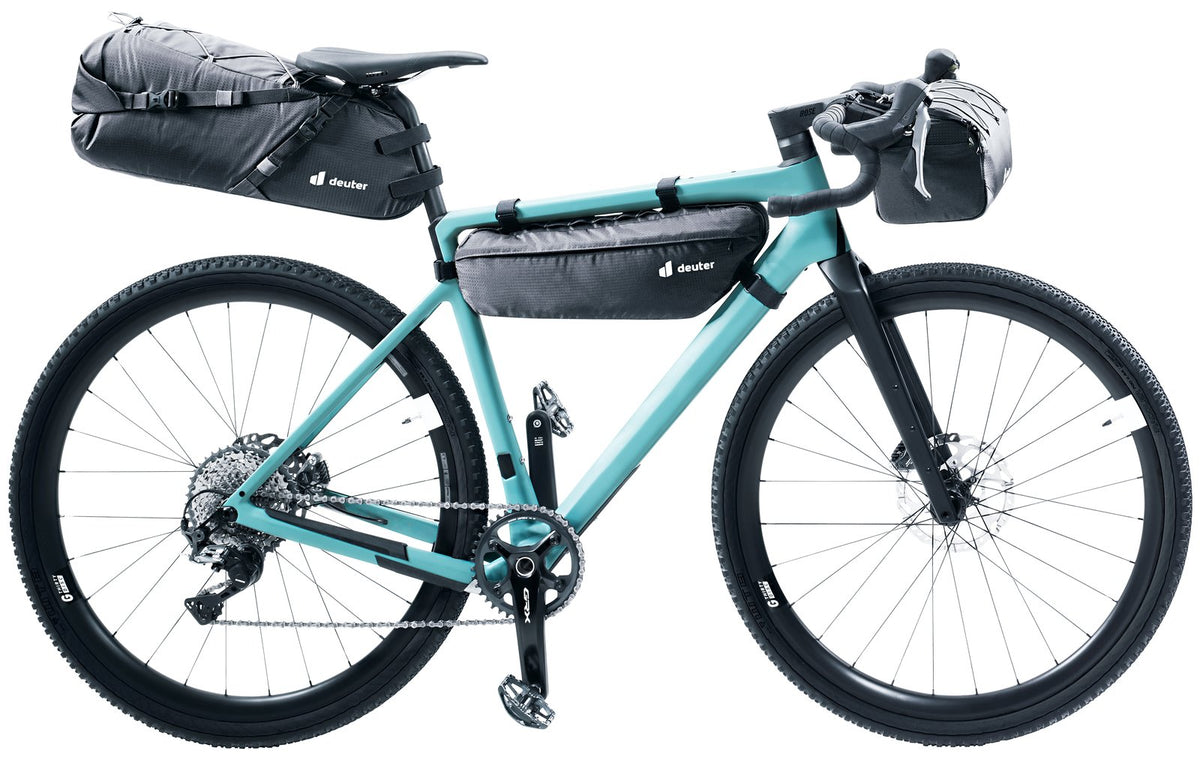 Teal gravel bike with a full Deuter bikepacking setup including the Mondego FB 6 frame bag