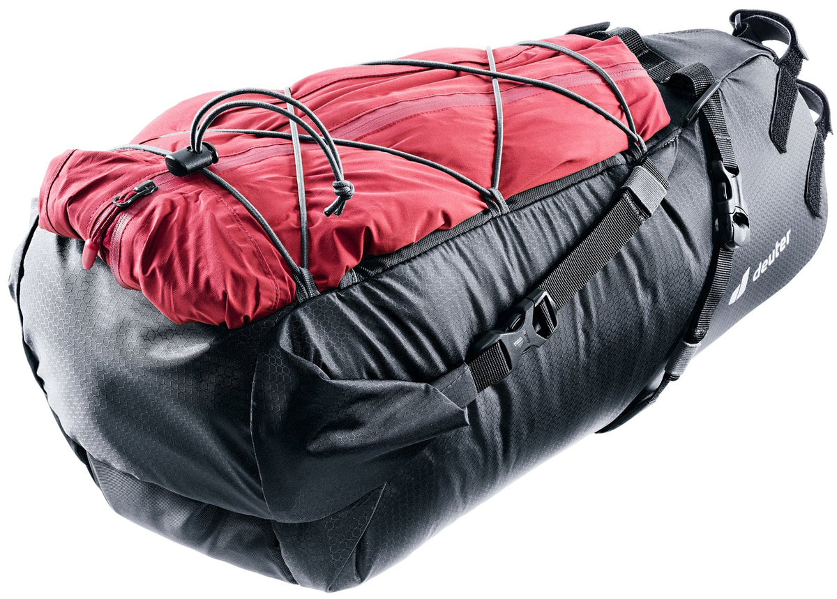 Deuter Mondego SB 16 with a red jacket held under the bungee cord on top