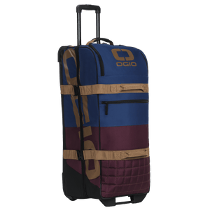 OGIO Trucker in Burgundy/Navy from the front left, front zip pocket and tan grab straps