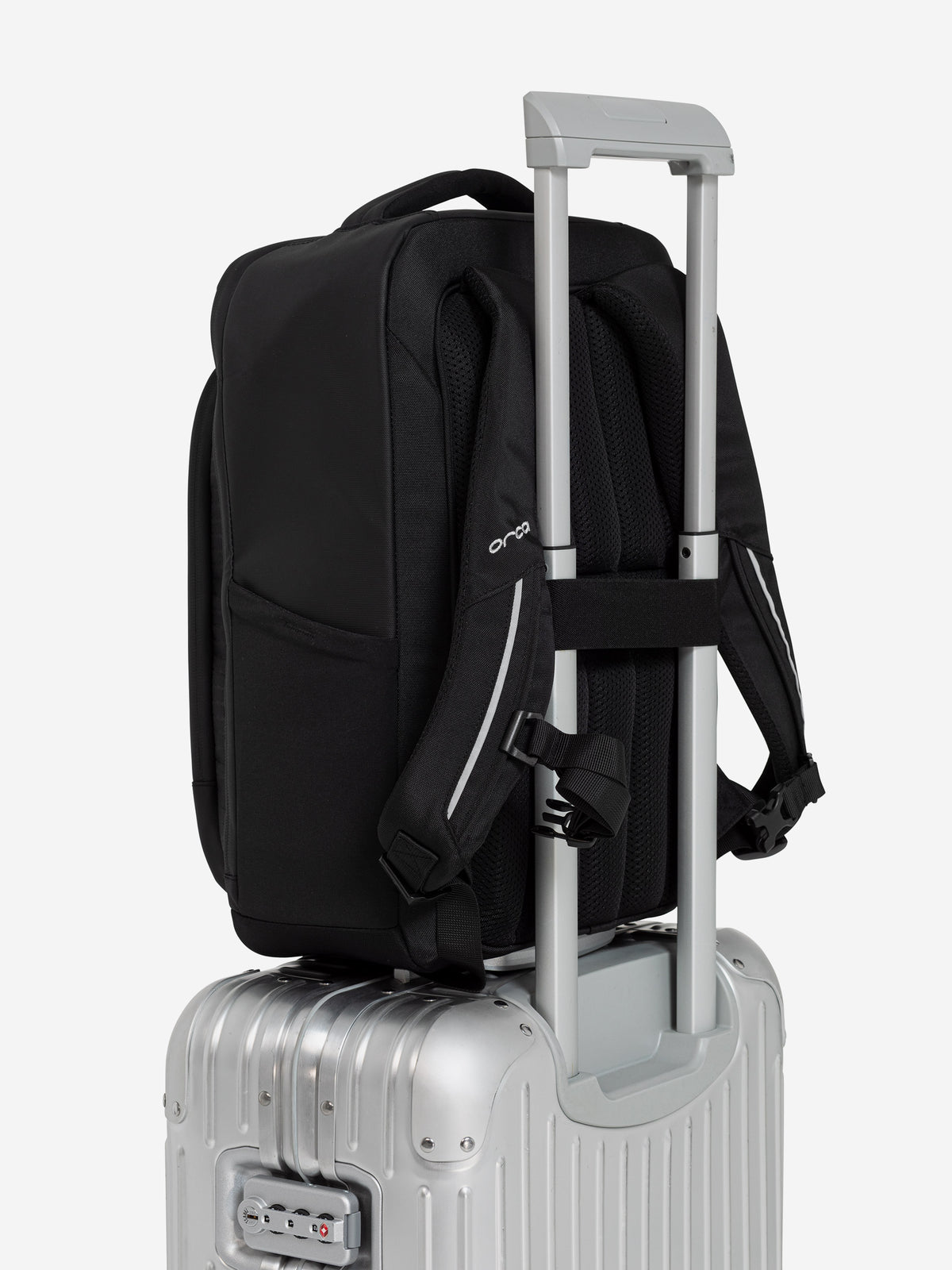 Orca Casual Backpack sitting on a suitcase handle using its rear trolley sleeve