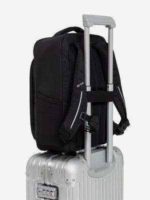 Orca Casual Backpack sitting on a suitcase handle using its rear trolley sleeve