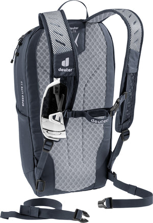 Deuter Speed Lite 13 with sunglasses held on the shoulder strap and the waist belt hanging loose