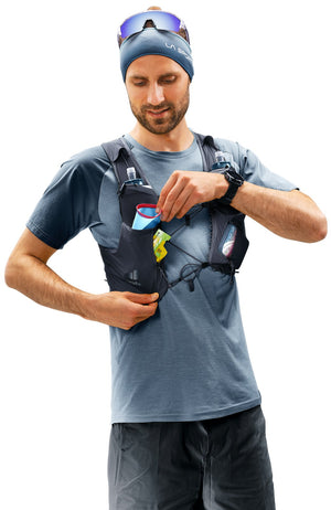 Runner reaching into a shoulder strap pocket of the Deuter Traick 5