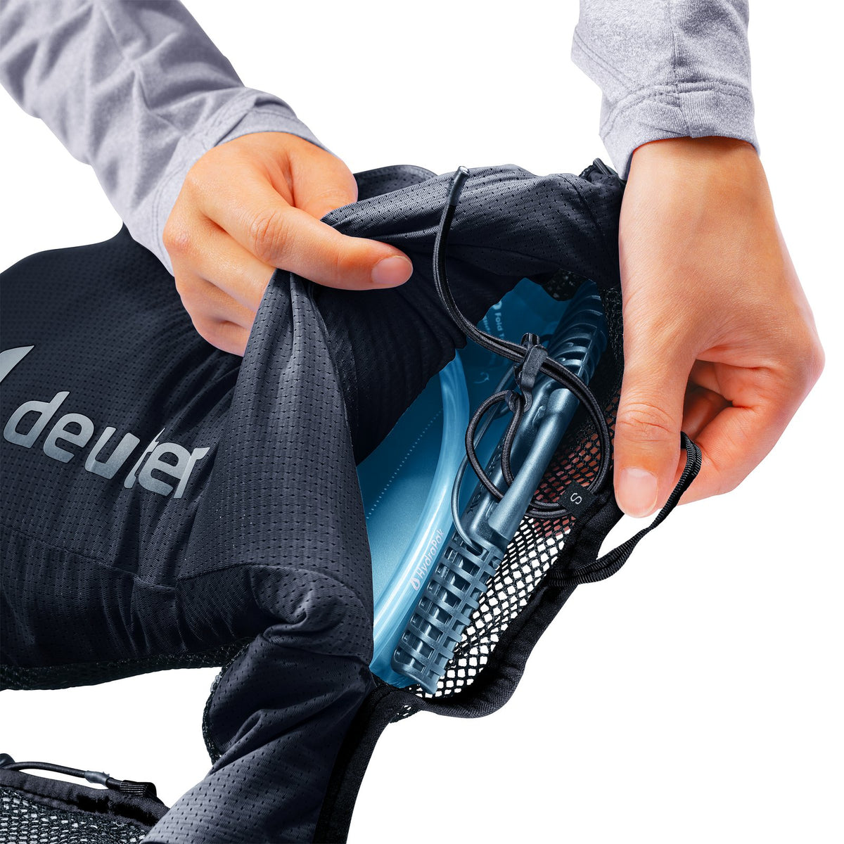 Hydration bladder (sold separately) sliding into the Deuter Traick 5 through the side access