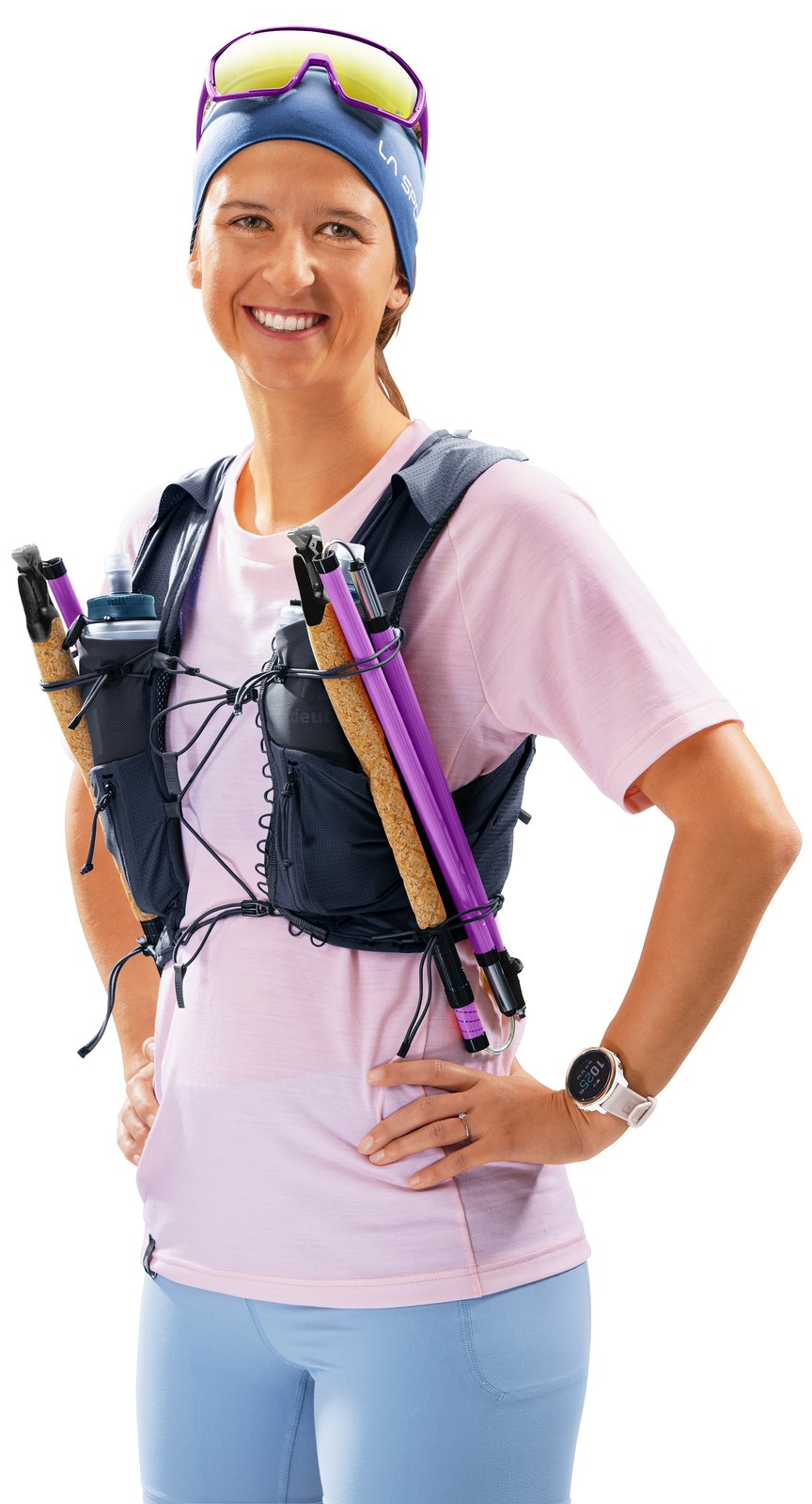 Woman wearing the Deuter Traick 9 SL with folded poles held on the front