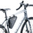 Deuter Triangle Bag 1.7 in Black strapped into the frame corner of a grey gravel bike