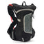 USWE Raw 4L hydration pack in Black/Grey, front three-quarter view with red drink tube