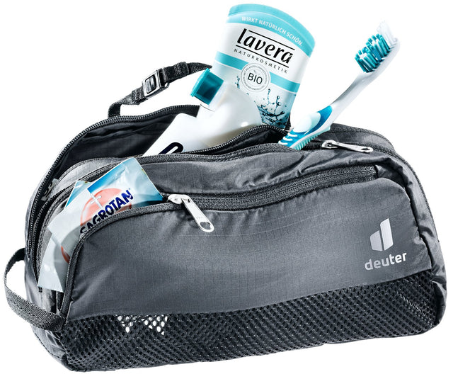Deuter Wash Bag Tour III in Black, unzipped and packed with toothbrush, toothpaste and toiletries