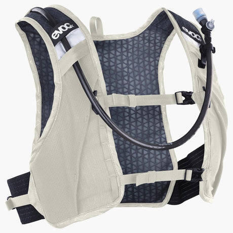 EVOC Hydro Pro Ultra 1.5 race vest in Sand, front three-quarter view with drink tube over the shoulder