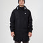 Man wearing the black XTM Innisfail II rain jacket and a grey beanie, showing the longer hip-length cut