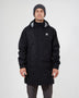 Man wearing the black XTM Innisfail II rain jacket and a grey beanie, showing the longer hip-length cut
